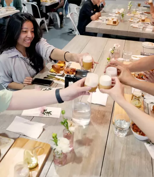 Guest Cheering On Communal Table